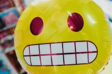 smiley face on balloon grinning